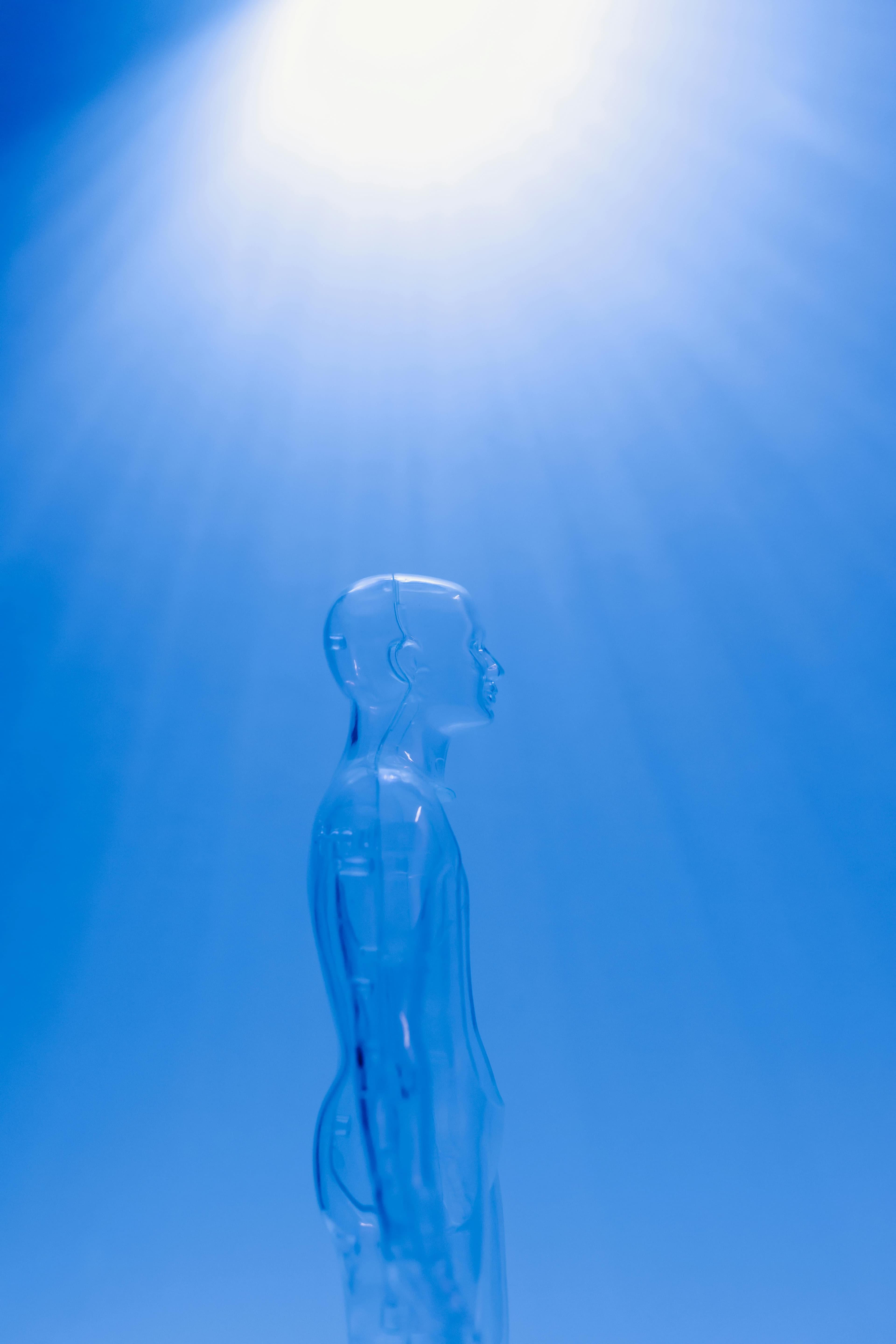 Transparent human figure under blue light rays symbolizing AI-powered literature and digital art